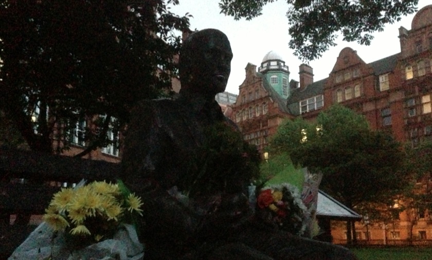 Alan Turing's Statue surrounded by flowers