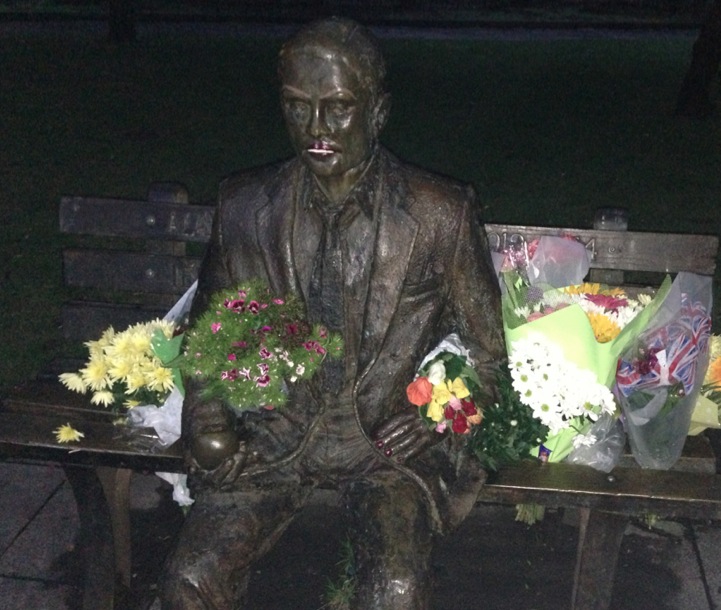 Alan Turing's Statue surrounded by flowers