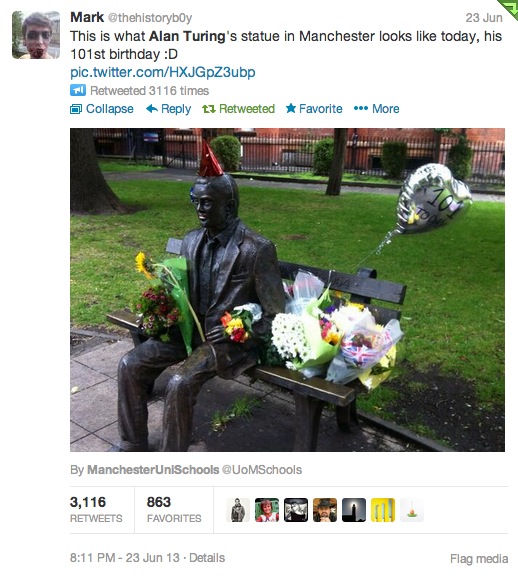 Alan Turing's Statue surrounded by flowers