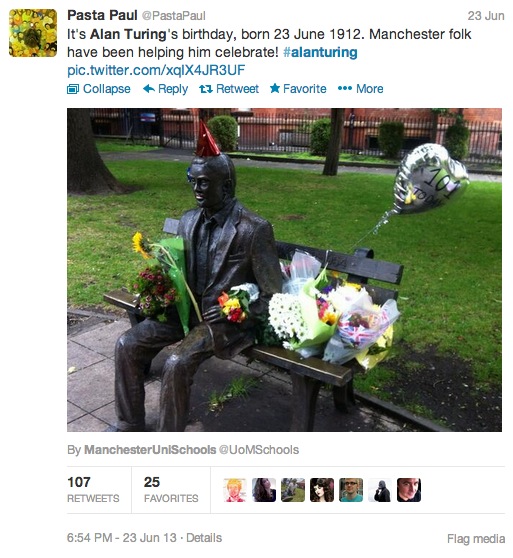 Alan Turing's Statue surrounded by flowers