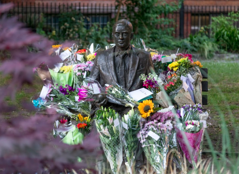 Flowers around statue