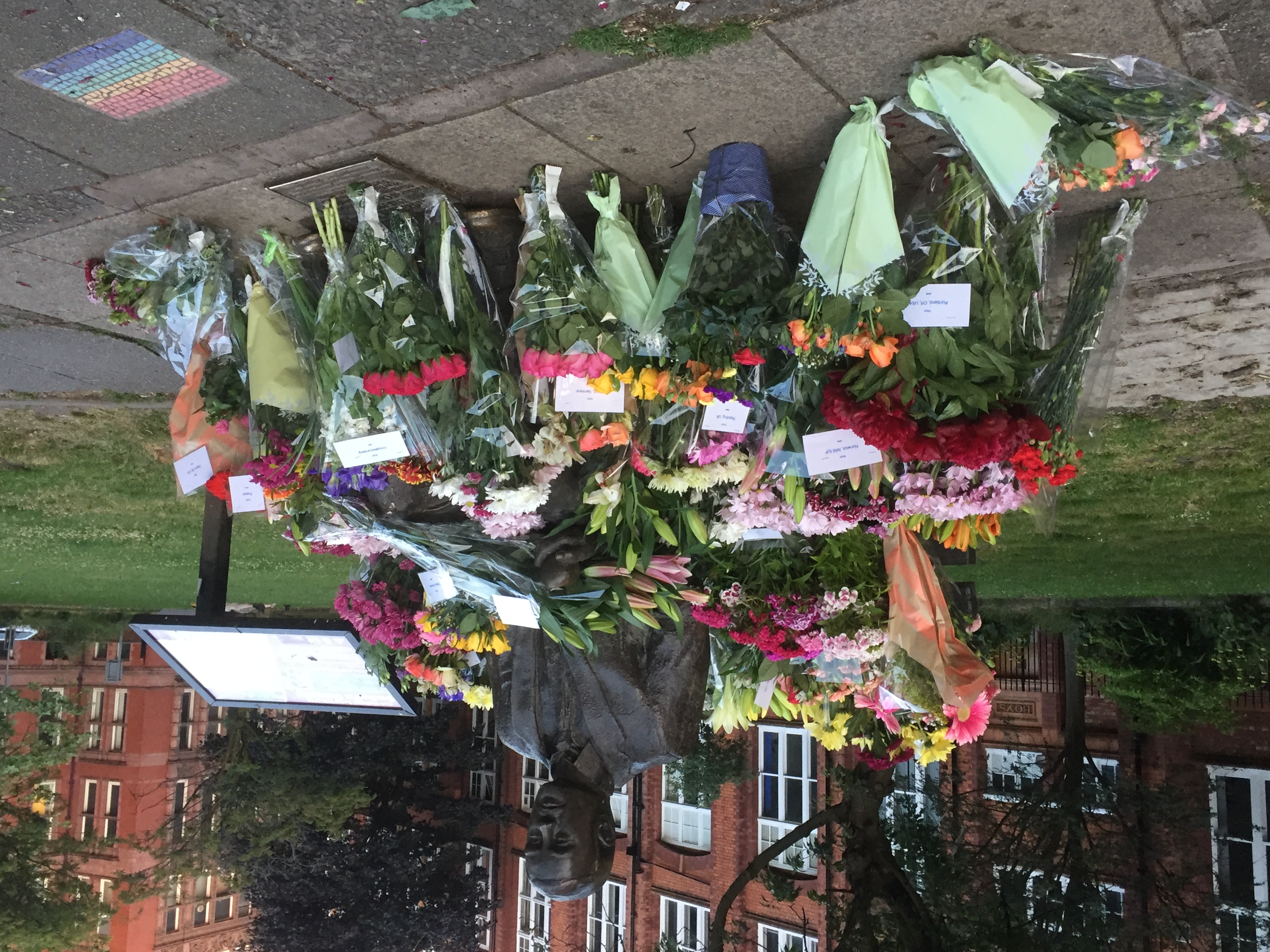 Photo of statue surrounded by flowers