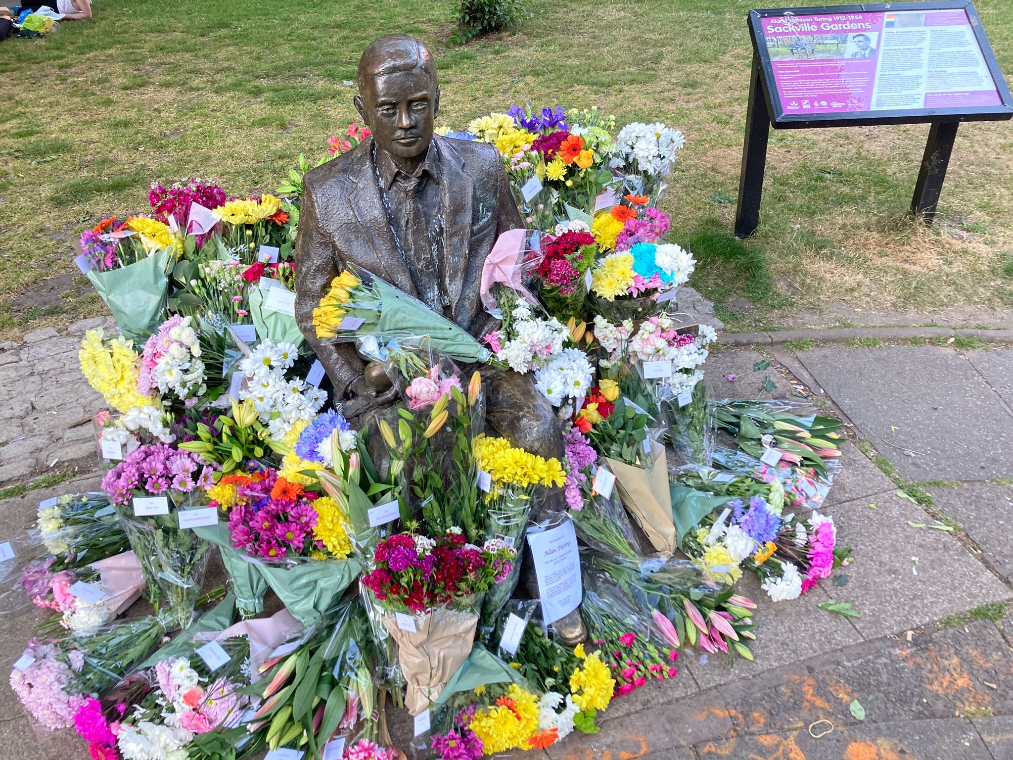 Photo of statue surrounded by flowers