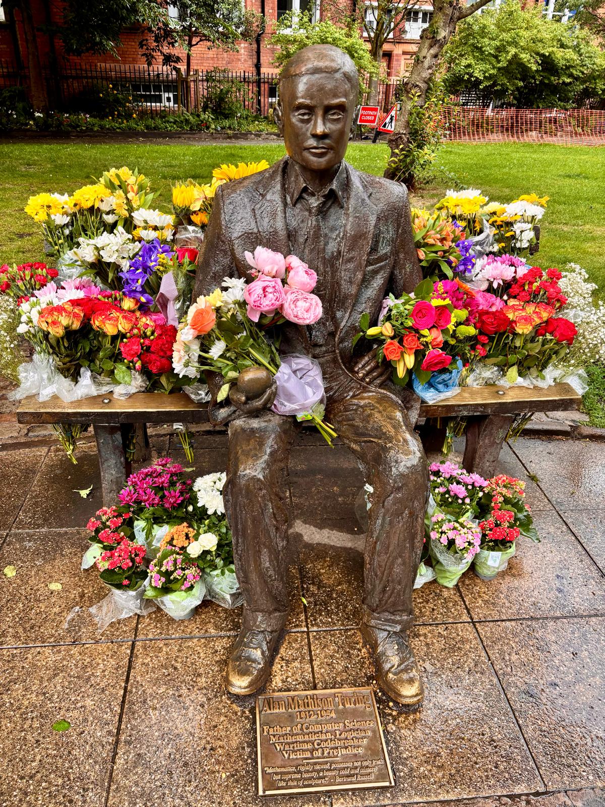 Photo of statue surrounded by flowers