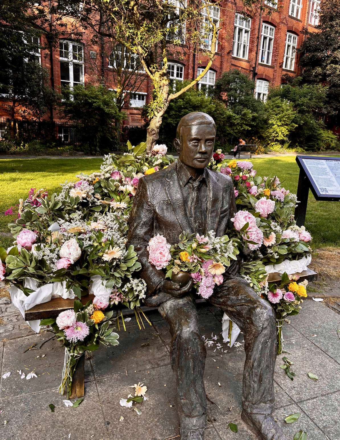 Photo of statue surrounded by flowers