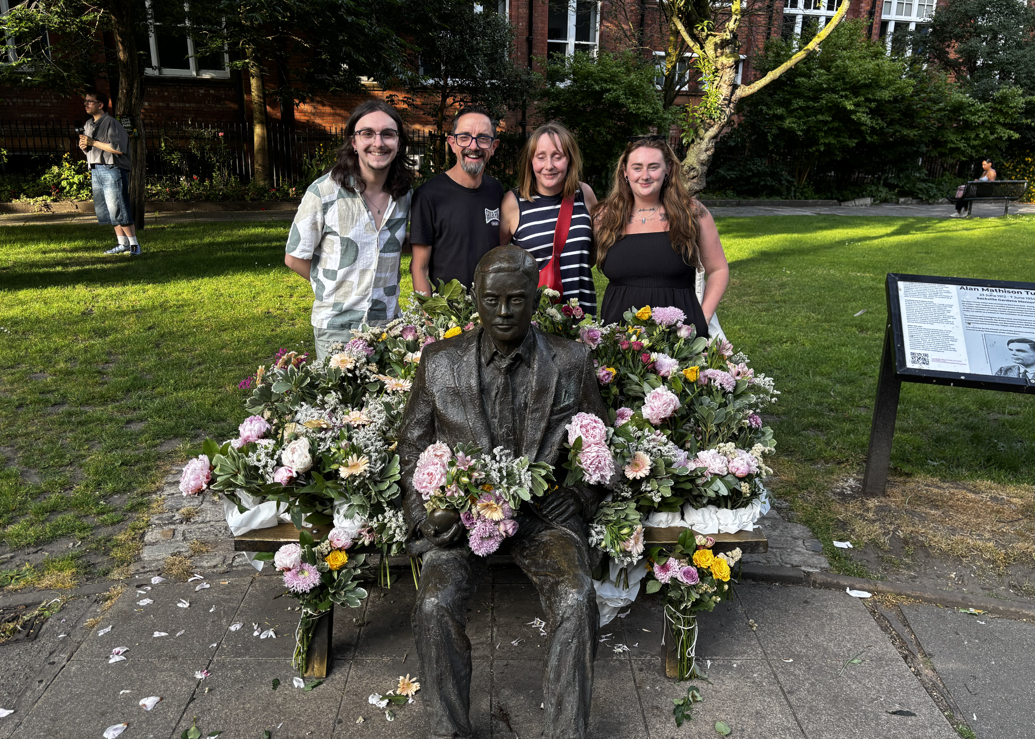 Photo of statue surrounded by flowers