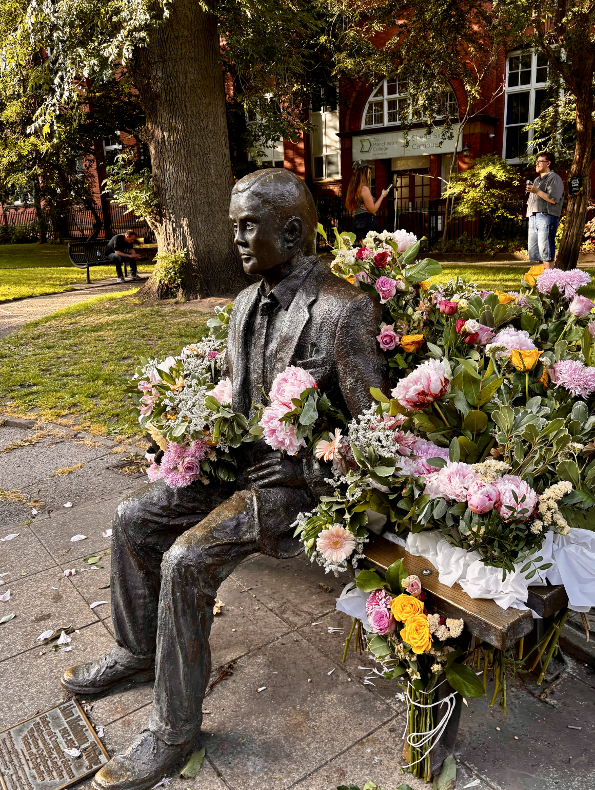 Photo of statue surrounded by flowers