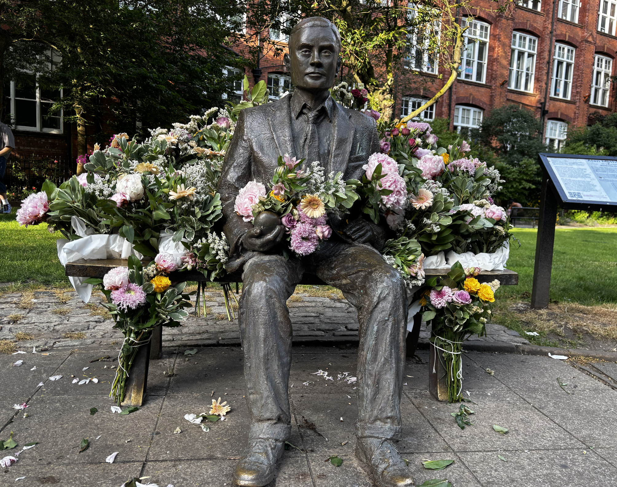 Photo of statue surrounded by flowers