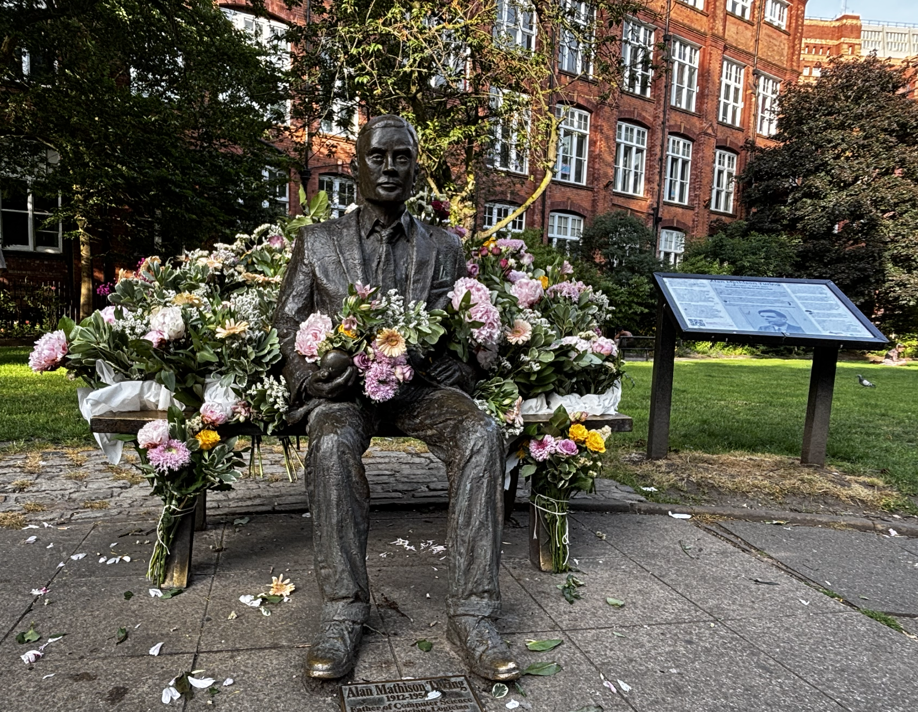 Photo of statue surrounded by flowers