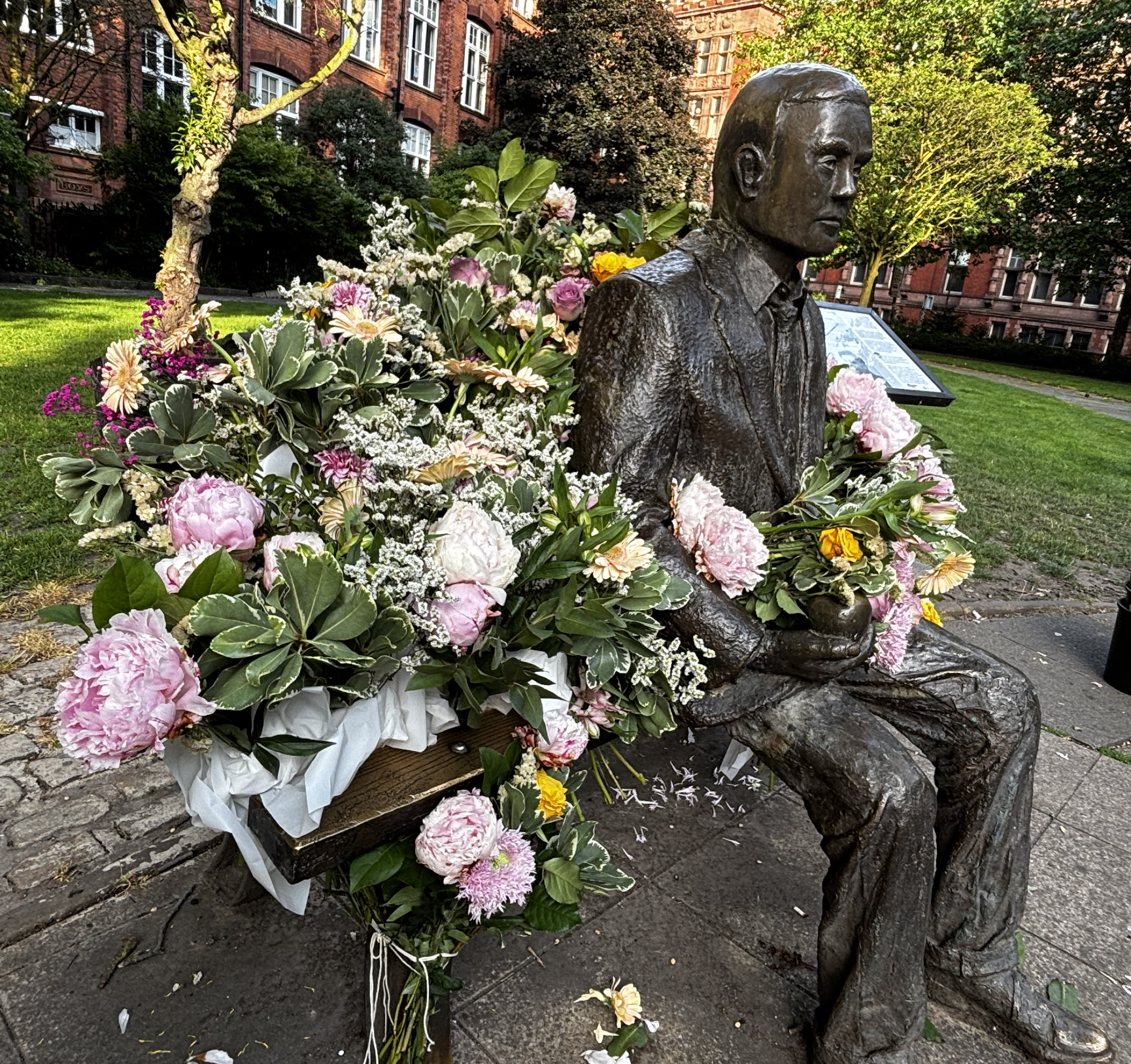Photo of statue surrounded by flowers