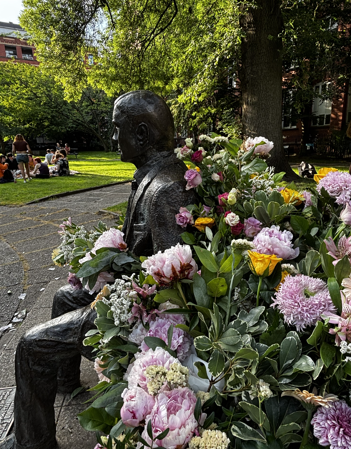 Photo of statue surrounded by flowers
