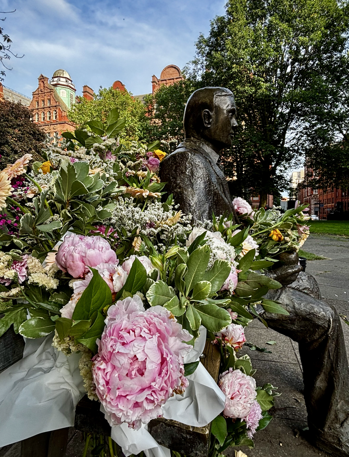 Photo of statue surrounded by flowers